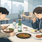 Two colleagues discussing work matters while eating a Korean lunch together, symbolizing how to talk...