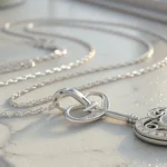 Close-up image of a delicate silver necklace with a broken clasp, symbolizing the topic of asking fo...