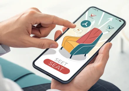 Illustration of a hand using a smartphone to select seats on a digital map, symbolizing online ticke...